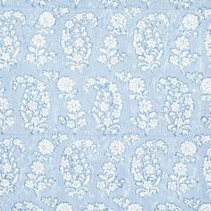 a blue and white wallpaper with floral designs on the top, in shades of light blue