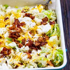 a salad with bacon, cheese and lettuce