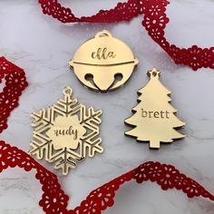 three personalized christmas ornament ornaments on a table