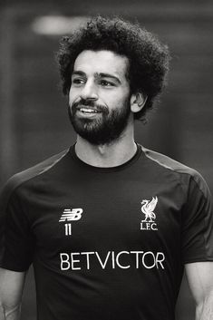 a black and white photo of a man with curly hair wearing a shirt that says betvctor