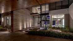 a modern house at night with stairs leading up to it