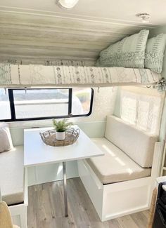 the inside of a camper with a table and couch