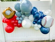 balloons and baseballs are hanging on the fence