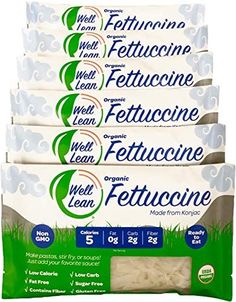 five packs of fettuccine for dogs, with grass in the middle and on top