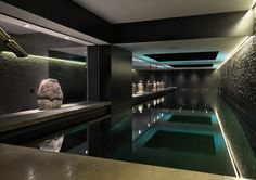 an indoor swimming pool with sculptures and lights