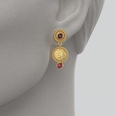 Discover our exquisite Made in Italy Dangle Earrings, crafted with meticulous artistry in either 14k or 18k gold and adorned with stunning natural Garnet cabochons ( 4 mm). Inspired by the grandeur of ancient Greece, these earrings feature a captivating reproduction of an ancient Greek coin, portraying the heroic Head of Herakles proudly donning the iconic lion skin. 14k or 18k gold Made in Italy Length 32 mm, Width 14 mm 14k Yellow Gold Gemstone Earrings, Gold Byzantine Jewelry With Cabochon, Byzantine Gold Jewelry With Cabochon, Byzantine Gold Cabochon Jewelry, Timeless Gold Jewelry With Cabochon, Timeless Gold Cabochon Jewelry, Timeless Gold Gemstone Earrings, Elegant Yellow Gold Jewelry With Cabochon, Elegant Yellow Gold Cabochon Jewelry