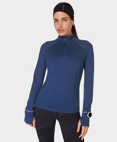 Our new, technical mid layer for run lovers. Made from a breathable ultra-soft fabric. Slim fit with half zip and contouring seamlines. Long sleeves with a watch hole and thumbhole mittens . One back zip pocket. Front length: 61cm / 24”. Model wears size S and is 178cm/5'10" tall. Style Code: SB9321Colour: Flux Blue Sweat Top, Swimwear Collection, Vest Top, Leggings Shop, Jumpers For Women, Half Zip, Sweater Hoodie, Soft Fabric, Jumpsuit Dress