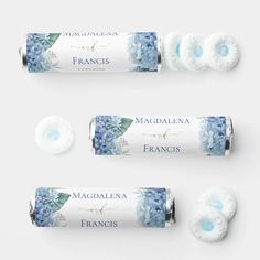 three rolls of soap next to each other with blue flowers on the top and bottom