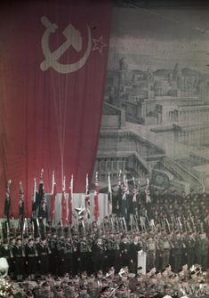 an old photo of people standing in front of flags