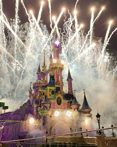 fireworks light up the night sky above a castle