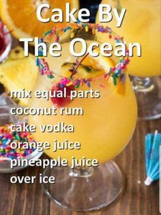 a cake by the ocean cocktail with sprinkles and orange slices on it