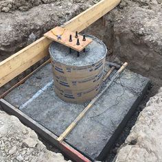 a large bucket sitting in the middle of a construction site with some screws sticking out of it