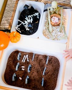 two trays filled with halloween treats on top of a table