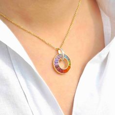 Introducing our extraordinary 18K Gold Rainbow Gemstones Diamond Circle Pendant Necklace—a celebration of vibrant hues and unparalleled sophistication. Crafted in luxurious 18-karat gold, this pendant features a captivating circle adorned with a spectrum of dazzling gemstones, including Aquamarine, Blue Topaz, Peridot, Citrine, Garnet, Rhodolite, and Amethyst. Artistic Multicolor Jewelry With Round Pendant, Multicolor Stone Round Pendant Necklace, Multicolor Gemstone Round Pendant Jewelry, Artistic Multicolor Round Pendant Jewelry, Rainbow Gemstone Pendant Necklace, Diamond Circle Pendant, Rainbow Gemstones, Circle Pendant Necklace, Circle Diamond