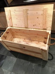 a wooden box sitting on top of a tile floor next to a green sign that says pallet projects how recycling falls can save you money on furniture