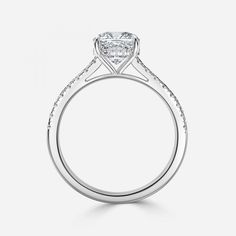 an engagement ring with a princess cut diamond in the center and pave set shoulders