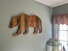 two wooden bears mounted to the side of a wall