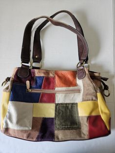 Vintage boho hippie style shoulder bag. Genuine leather, multi color patchwork with shoulder straps. Inside open pockets made for glasses, phone, or accessories. Outside zipper pocket. Gently used, very clean. Two small marks on leather squares shown in pictures, vintage wear on shoulder straps also shown. Daily Use Patchwork Satchel Hobo Bag, Patchwork Satchel Hobo Bag For Everyday Use, Patchwork Satchel Hobo Bag For Daily Use, Multicolor Patchwork Hobo Bag For Everyday Use, Multicolor Patchwork Hobo Bag For Daily Use, Brown Rectangular Hobo Bag With Patchwork, Multicolor Patchwork Tote Satchel, Multicolor Patchwork Satchel Shoulder Bag, Brown Patchwork Hobo Bag For Daily Use