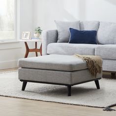 a living room scene with focus on the footstool and ottoman in the foreground