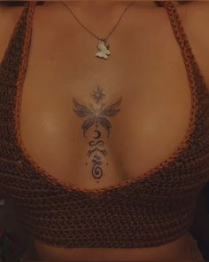 a woman's chest with a tattoo on the top and bottom part of her body