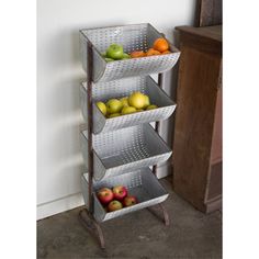 three tiered metal fruit rack with apples and oranges