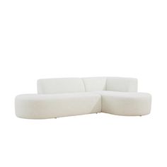 a white couch sitting on top of a white floor