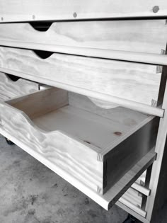 the bottom section of a bed with drawers