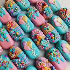 many decorated cookies sitting on top of a table