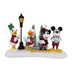 three mickey mouse figurines standing in front of a lamp post with a christmas tree