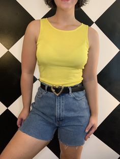 "That 1990s neon just hits different. Vintage 1990s neon yellow silky feel tank top. The color is so vibrant and eye catching, I just love it! Very simple tank; crew neck with simple cut sleeveless, straps are 1.25in in the thinnest part. Nice small ribbed texture to the material with a lot of stretch, it is 95% polyester and 5% spandex. In very good condition, just a few threads loose at the hem. The tag is fairly faded so I cannot see a size, but I am thinking a modern small. From \"NY-5\". Measurements (in inches, laying flat): Width: 16.5-24 Length: 21" Solid Color Y2k Sleeveless Tank Top, Y2k Style Sleeveless Tank Top, Y2k Style Spring Tank Top, Y2k Style Solid Color Tank Top For Summer, Solid Color Y2k Tank Top For Summer, Y2k Crew Neck Tank Top For Summer, Y2k Style Summer Tank Vest, Fitted 90s Style Tank Top For Spring, Retro Stretch Summer Tank Top