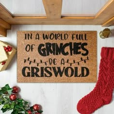 a christmas door mat that says in a world full of grinches there is a griswol