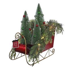 a red sleigh with christmas trees in it