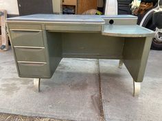 an old metal desk sitting on the sidewalk