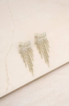 Endow night-out looks with shake and shimmer when you put on these light-catching fringe earrings lined with crystals. 3" drop; 1" width Goldtone plate/glass Imported Gold Crystal Tassel Earrings For Evening, Evening Crystal Earrings With Rhinestone Fringe, Glamorous Crystal Tassel Earrings For Evening, Gold Crystal Earrings With Rhinestone Fringe, Gold Chandelier Earrings With Rhinestone Fringe For Party, Glamorous Rhinestone Fringe Tassel Earrings For Party, Glamorous Party Crystal Earrings With Rhinestone Fringe, Glamorous Wedding Tassel Earrings With Rhinestone Fringe, Evening Rhinestone Fringe Dangle Chandelier Earrings