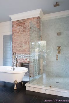 a bathroom with a white tub and black floor