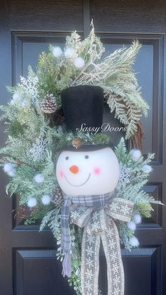 a wreath with a snowman wearing a top hat