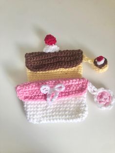 three crocheted purses sitting next to each other on top of a table