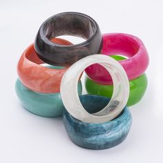 five different colored rings sitting on top of each other