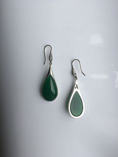 A pair of vintage dark green jade earrings. The teardrop-shaped earrings are made from quality green jade and 925 sterling silver hooks. The big emerald-like green jade drops are heavy-duty, comes with antique silver hooks. It's truly a great combination of modern minimalistic design and ancient Chinese royalty taste. Some highlights of this elegant and fancy dangle silver jade earrings are: *High-quality materials Quality green jade, 925 sterling silver. Great for sensitive skins and ensure lon Vintage Drop Earrings For Pierced Ears, Classic Green Drop Jewelry, Classic Green Drop Earrings, Vintage Jade Round Earrings, Silver Jade Earrings As Gift, Pierced Jade Dangle Earrings, Elegant Nickel-free Green Earrings, Elegant Green Nickel-free Earrings, Vintage Green Jade Earrings