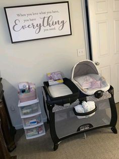 a baby's crib in front of a sign that says, when you love what you have, you are everything