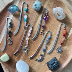 a wooden tray topped with lots of different types of jewelry