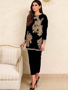 <p><strong>Top:</strong></p> <ul> <li>Color: Black</li> <li>Fabric: Velvet</li> <li>Shirt adorned with embroidery and intricate hand embellishments</li> </ul> <p><br /><strong>Bottom:</strong></p> <ul> <li>Color: Black</li> <li>Fabric: Velvet</li> <li>Complement with plain cropped trouser</li> </ul> <p><br /><strong>Dupatta:</strong></p> <ul> <li>Color: Black</li> <li>Fabric: Chiffon</li> <li>Dupatta contains sequins spray all over</li> </ul> <p><br /><strong>Embellishment work made with:</stron Trouser Suits For Women, Sadaf Fawad Khan, Black Velvet Suit, Fawad Khan, Red Bridal Dress, Cropped Trouser, Velvet Dress Designs, Trouser Suit, High Fashion Photography