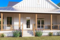 a small white house with porches and windows