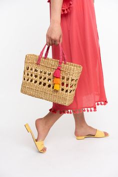 A fun twist on your old beach bag, elevated with a hand woven design. Both the bright handle and pom take this bag to the next level! Details: Size 13w x 9.5h 100% Natural Rattan with Jute Handle. Colorful tassel. Playful Rectangular Beach Bag For Summer, Playful Summer Beach Bag For Vacation, Playful Beach Bag For Summer Vacation, Spring Crochet Beach Bag With Tassels, Summer Beach Bag With Tassels For Shopping, Rectangular Summer Beach Bag With Tassels, Rectangular Beach Bag With Tassels For Summer, Playful Rectangular Beach Bag For Vacation, Rectangular Straw Bag For Summer Outings