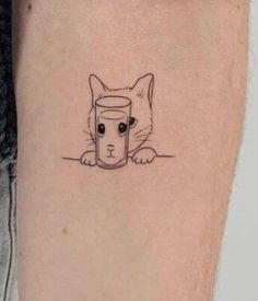 a cat with a cup on it's leg is shown in this tattoo design