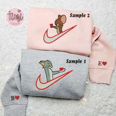 Tom And Jerry Giving Heart x Nike Couple Embroidered Shirt, Cartoon Embroidered Hoodie, Valentine’s Day Embroidered Sweatshirt Welcome to Tinicloset, a haven for personalized fashion enthusiasts and lovers of iconic cartoons alike. Nestled within our vibrant shelves, an exquisite array of custom embroidered shirts, sweatshirts, T-shirts, and hoodies beckon, each piece a canvas for individual expression and nostalgia. Picture this: the Tom and Jerry Giving Heart x Nike Couple embroidered sh Nike Couple, Cartoon Hoodie, Matching Hoodies, Embroidered Shirts, Couples Sweatshirts, Couples Hoodies, Lady And The Tramp, Embroidered Sweatshirt, Tom And Jerry