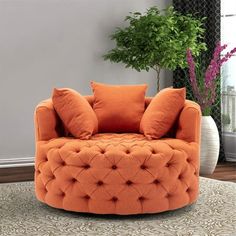 an orange chair sitting on top of a rug