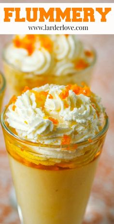 two desserts with whipped cream and orange zest on top are sitting in small glasses