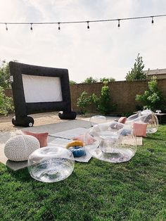 an inflatable screen is set up on the lawn with balls and other decorations