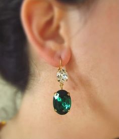 Beautiful large glass crystals in Emerald Green are offset by a sparkling vintage glass crystal. A classic and versatile pair of earrings! Stone Length: 1 inch (2.5 cm)Total Earring Length: 1 1/2 inches (3.8cm)Setting Material: Nickel Free Cast Brass, your choice of Gold (shown), Antique Gold, Antique Silver or Silver plating. These settings have sturdy, secure lever-back earrings so you can be sure they won't slip out while you are wearing them. Ornate Gemstone Earrings For Formal Occasions, Oval Green Cubic Zirconia Earrings, Ornate Gemstone Drop Earrings, Luxury Green Oval Cabochon Earrings, Elegant Green Gemstone Clip-on Earrings, Earrings Stone, Cross Pendant Necklace, Large Earrings, Glass Crystal